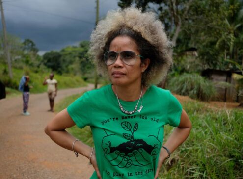 A woman wearing a green shirt standing outside