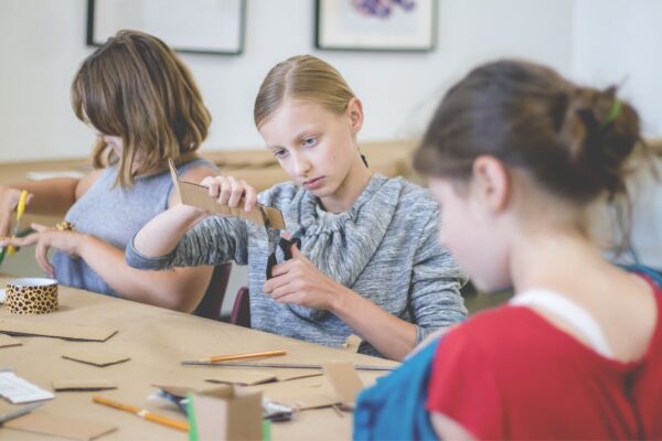 Kids working on an arts project around a table