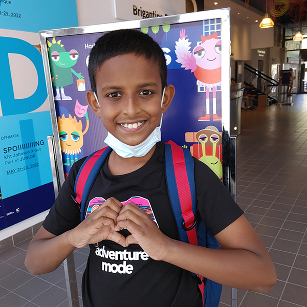 Smiling Tajwar making a heart shape with his hands