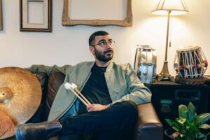 A man sitting on a couch posing for the camera.
