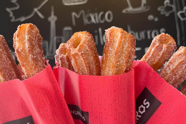 Tasty looking churros in paper wrappers