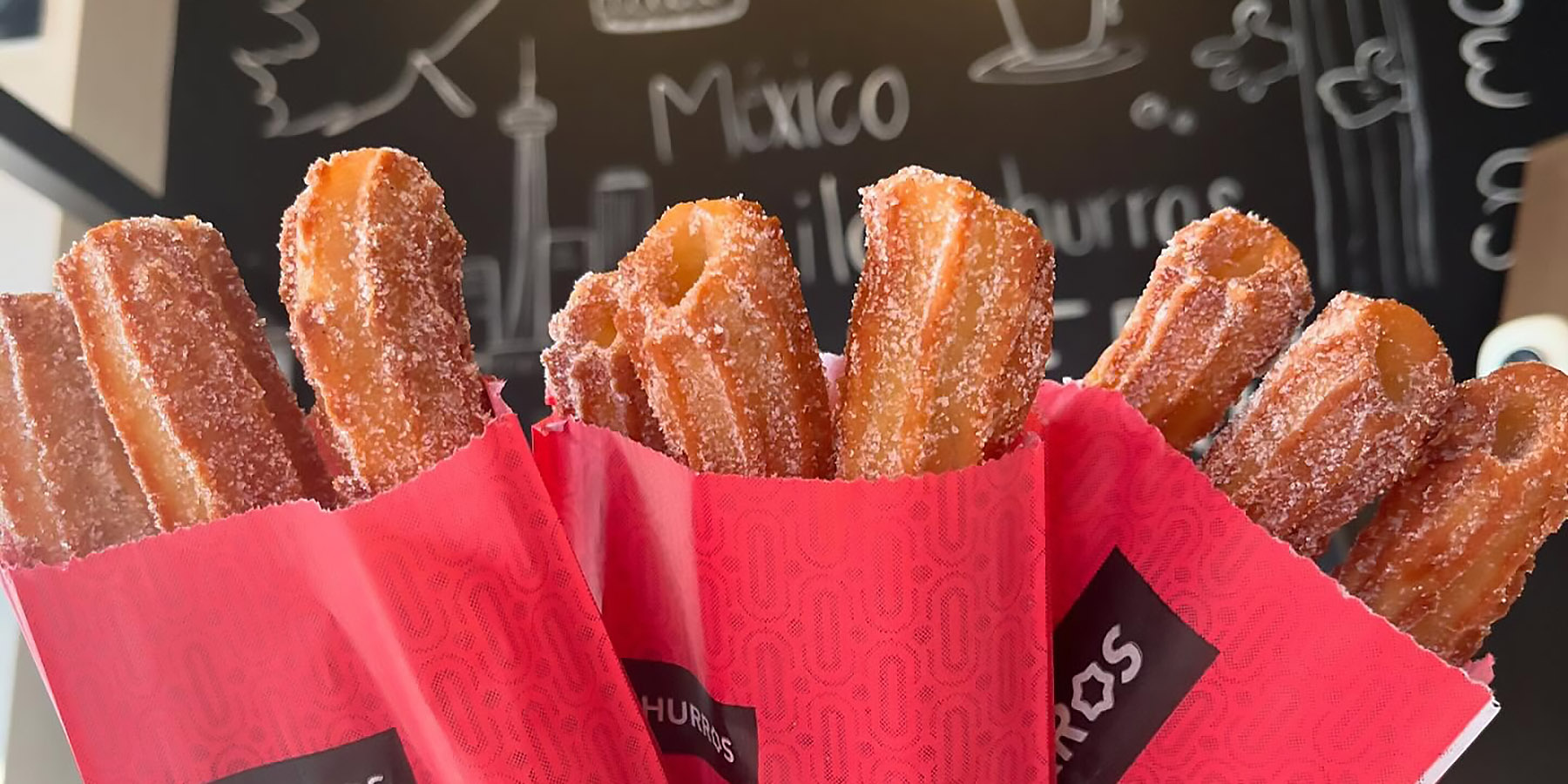 Tasty looking churros in paper wrappers