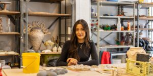 Artist working on ceramic craft in studio