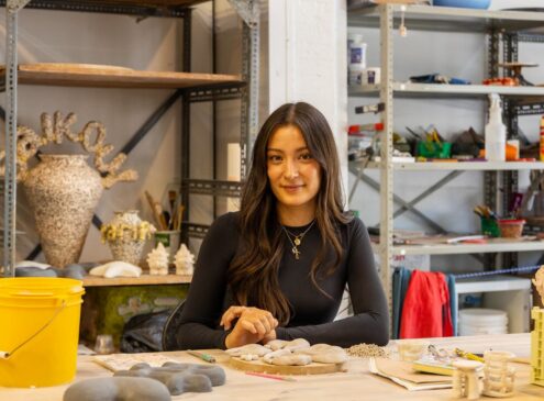Artist working on ceramic craft in studio