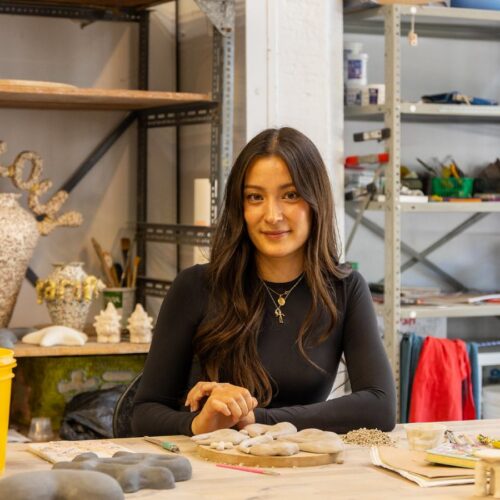 Artist working on ceramic craft in studio