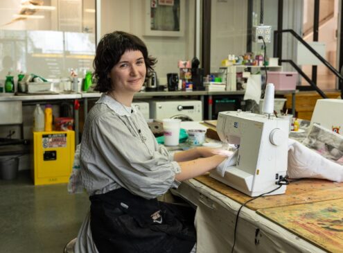 Artist working on textile craft in studio