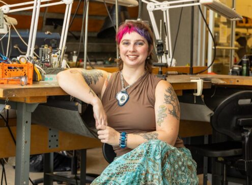 Artist working on metal craft in studio