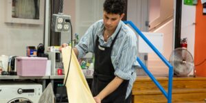 Artist working on textile craft in studio