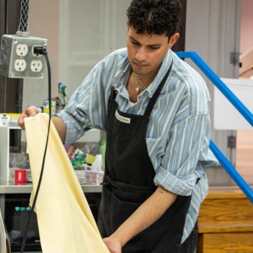Artist working on textile craft in studio