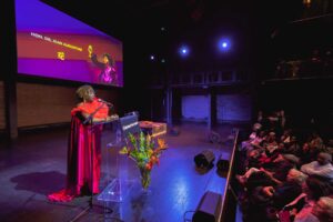 A woman speaks at a podium.
