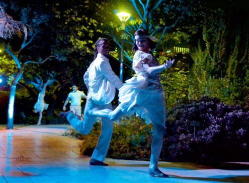 Two dancers dancing at night outside