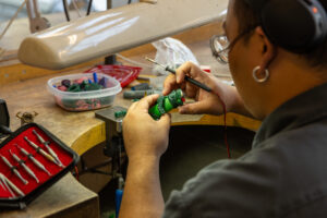 Artist working on metal craft in studio
