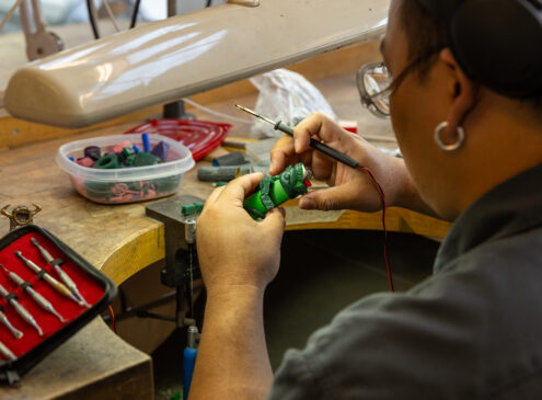 Artist working on metal craft in studio