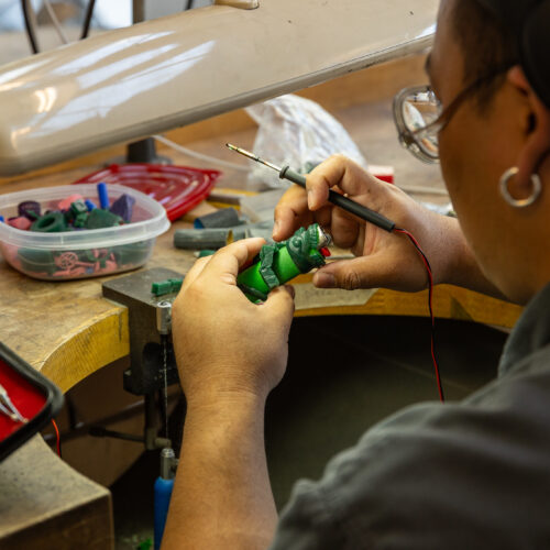 Artist working on metal craft in studio
