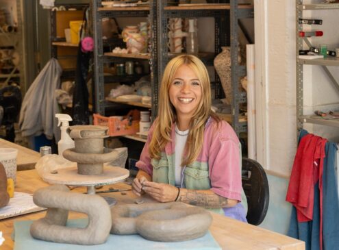 Artist working on ceramic craft in studio