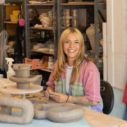 Artist working on ceramic craft in studio