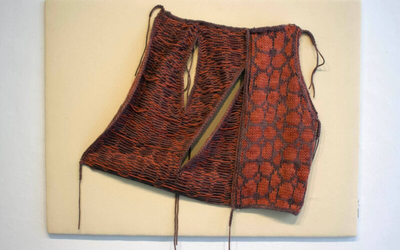 An up-close shot of a red textile work