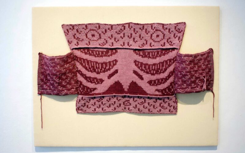 An up-close shot of a red textile work