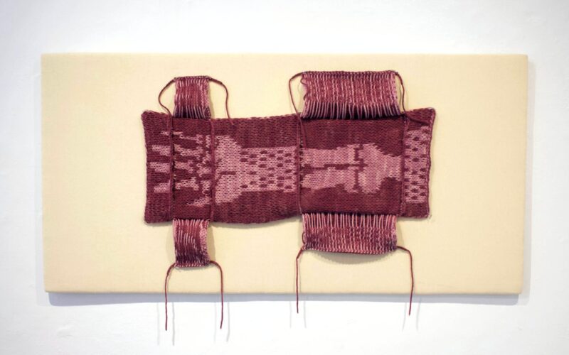 An up-close shot of a red textile work