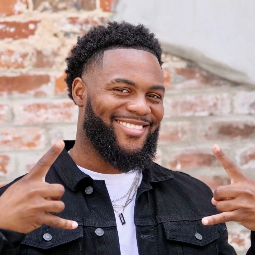 A man gesturing with his hands posing for the camera