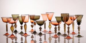 A row of colourful glasses against a white background