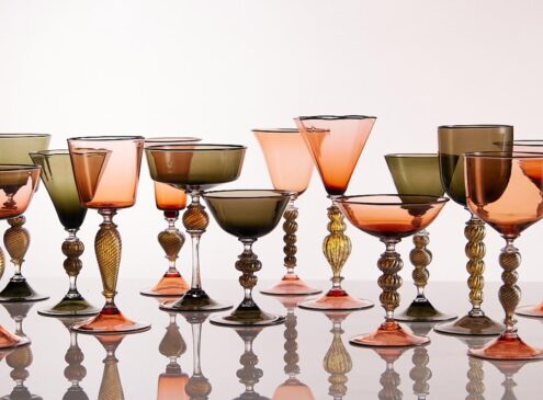 A row of colourful glasses against a white background