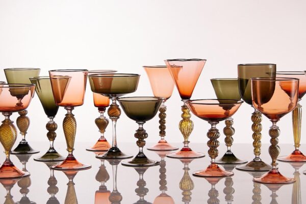 A row of colourful glasses against a white background