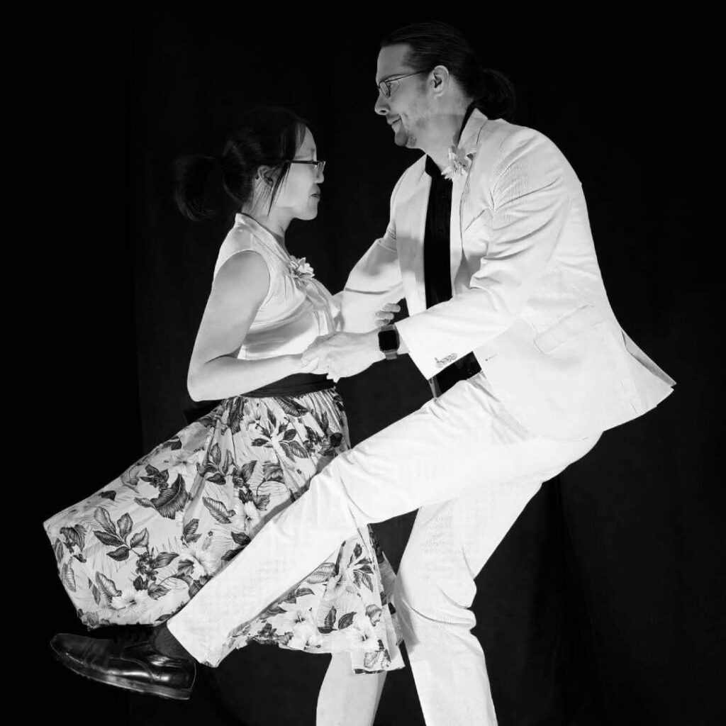 A black and white image of a couple dancing