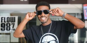 A man wearing sunglasses and a black shirt posing for the camera