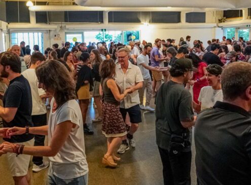 A crowd of people dancing in a room