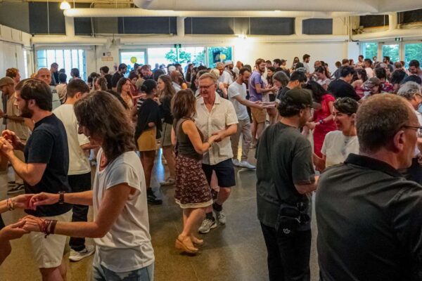 A crowd of people dancing in a room