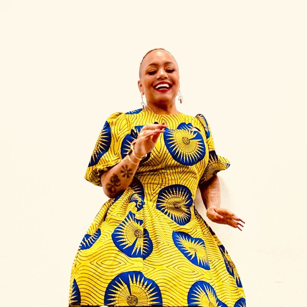 A woman wearing a bright yellow and blue dress