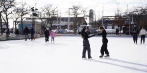 People skating on an outdoor rink during winter
