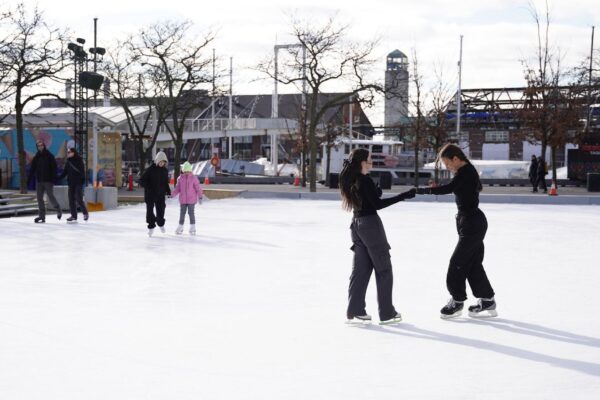 People skating on an outdoor rink during winter