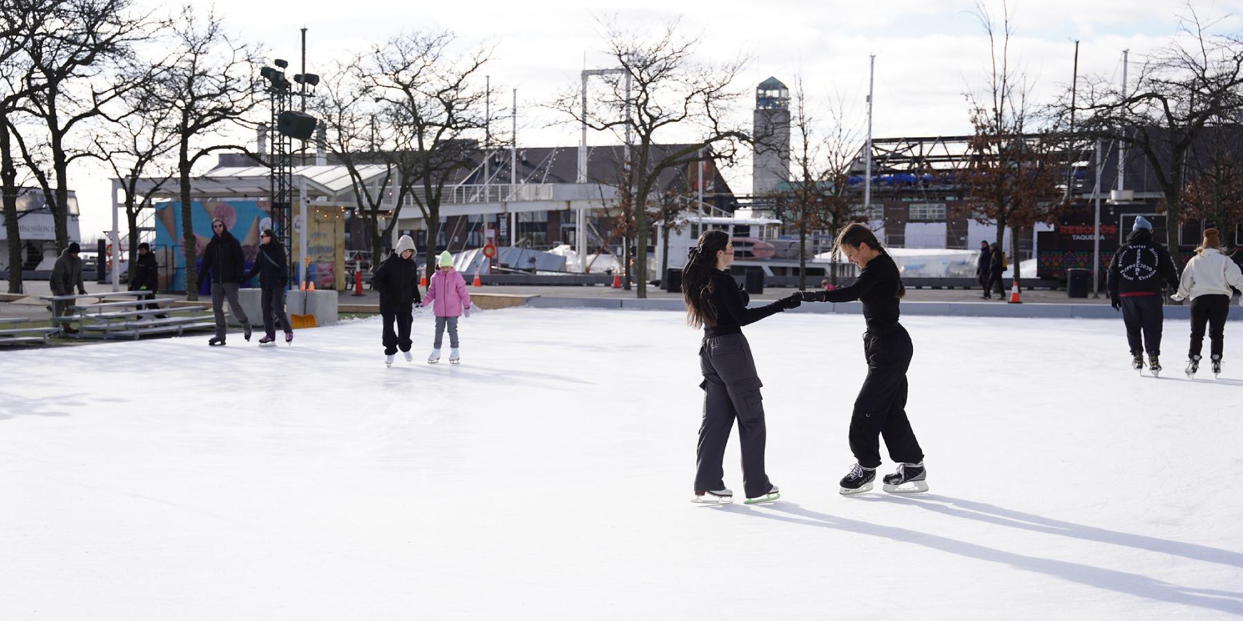 People skating on an outdoor rink during winter