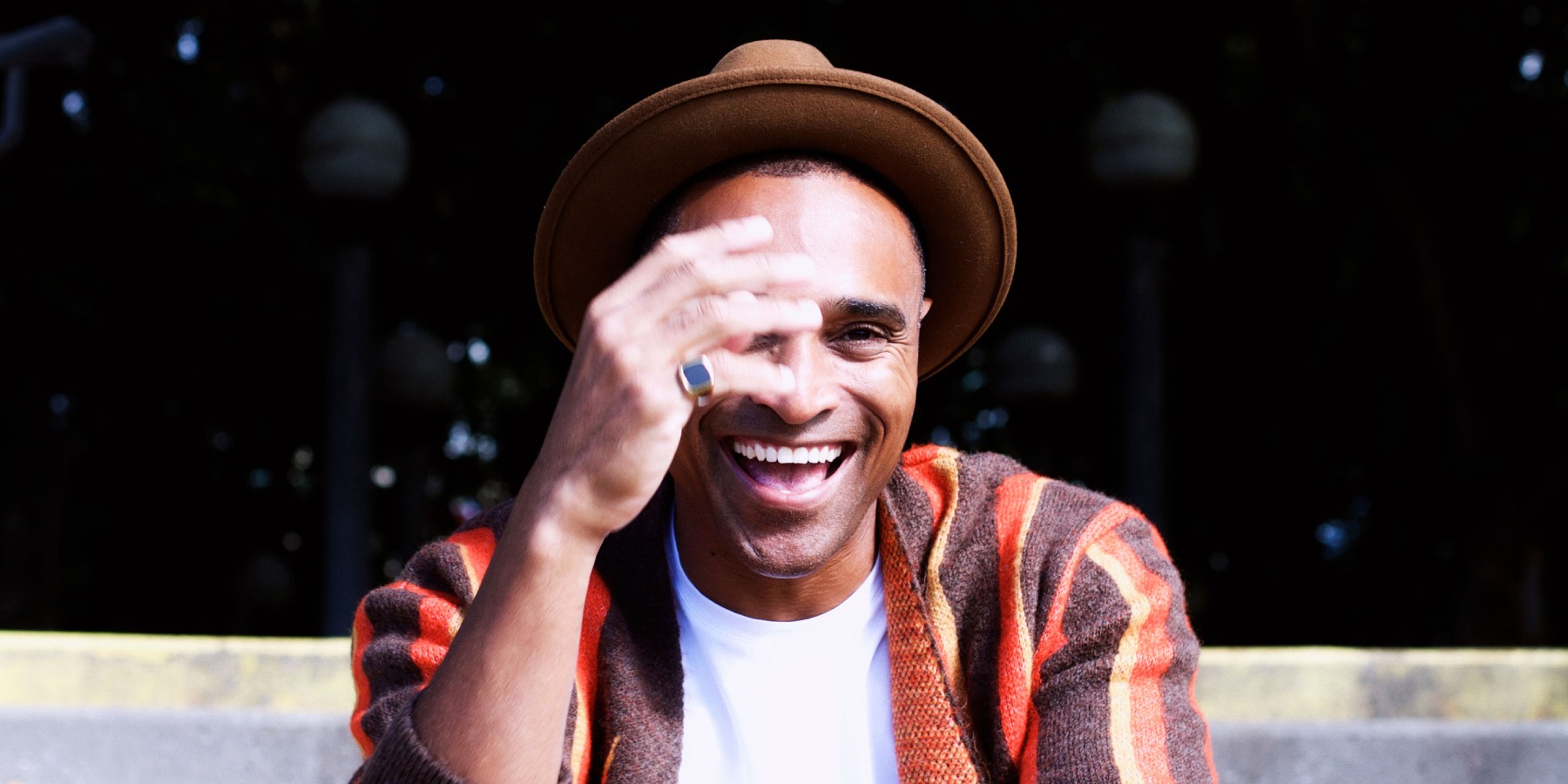 A man wearing a hat and posing for the camera