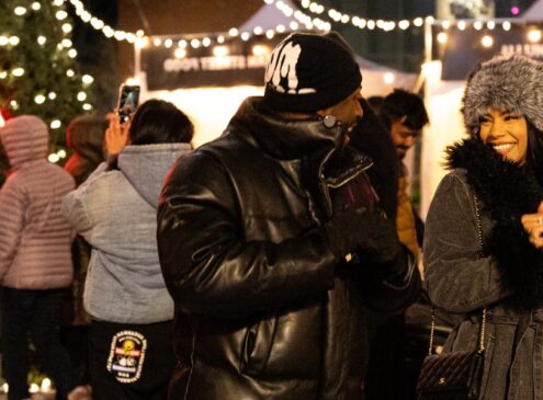 A crowd of people at an outdoor holiday market