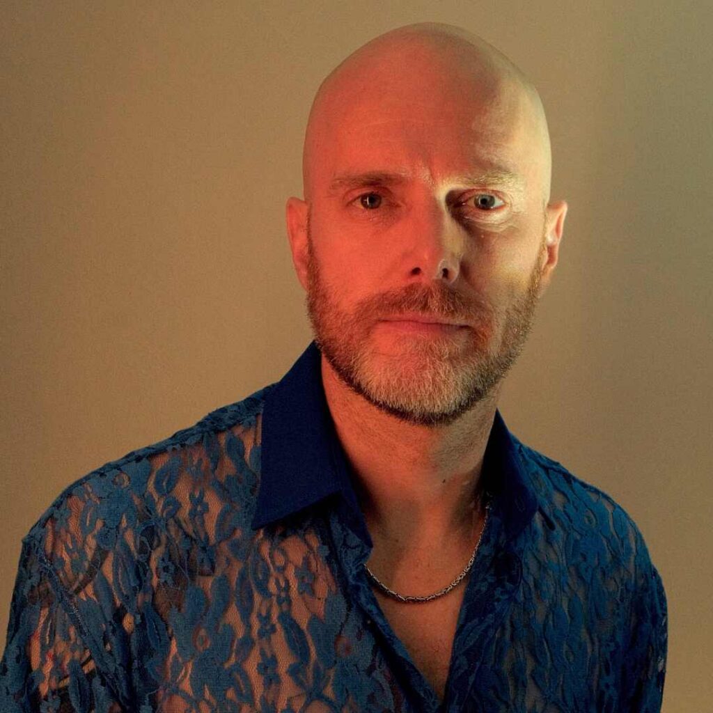 A close-up shot of a man posing for the camera