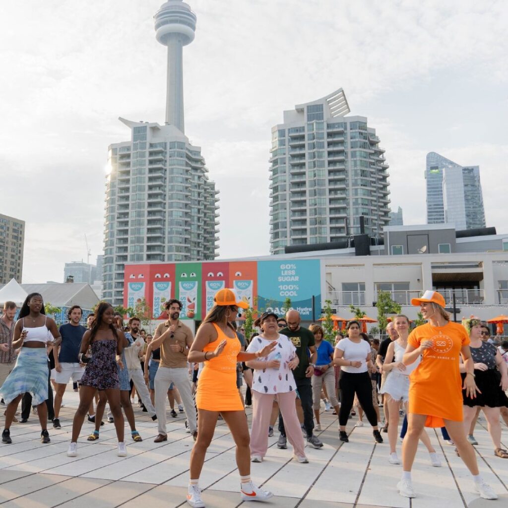People dancing at an outdoor square at Harbourfront