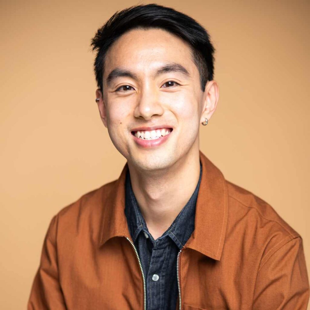 A headshot of a man smiling