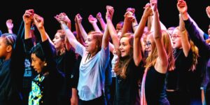 A group of girls doing a theatre performance holding hands