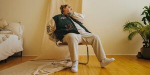A person sitting on a chair posing looking away from the camera