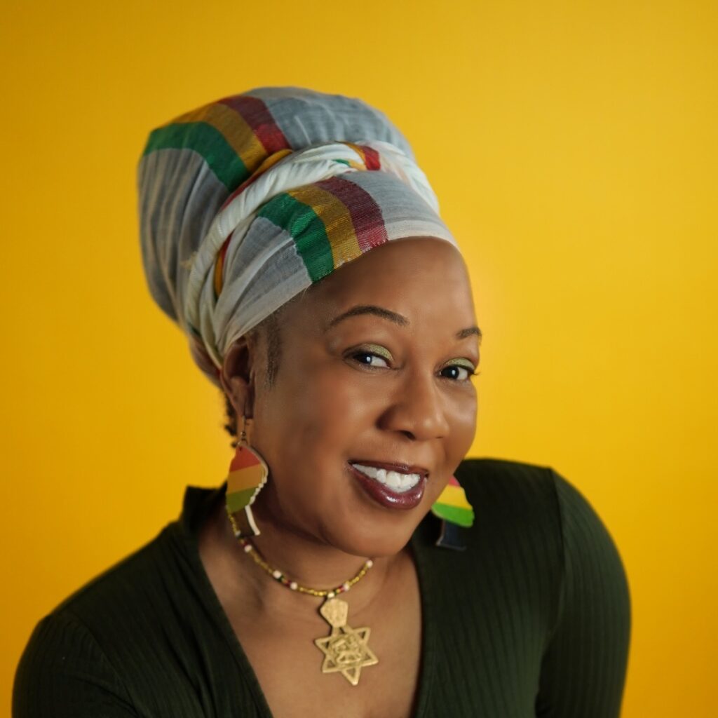 A woman posing for the camera against a bright yellow background