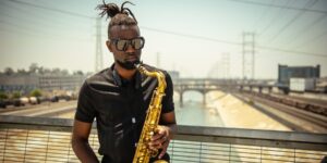 A man playing a saxophone outside