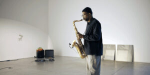 Dennis Passley performing in a white room