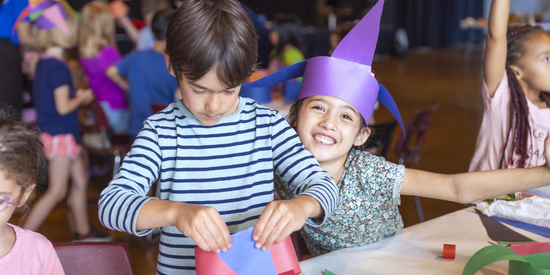 Two children doing arts and crafts at camp