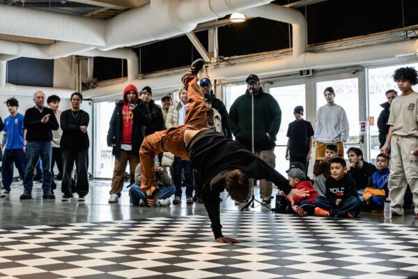 A crowd watching breakdancers