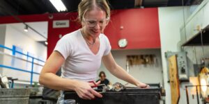 Artist working on a glass piece in the studio