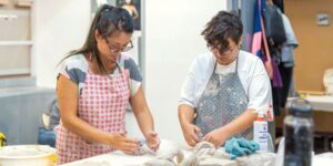 Two artists working on ceramics in the studio