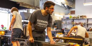 A group of glass artists working in the studio